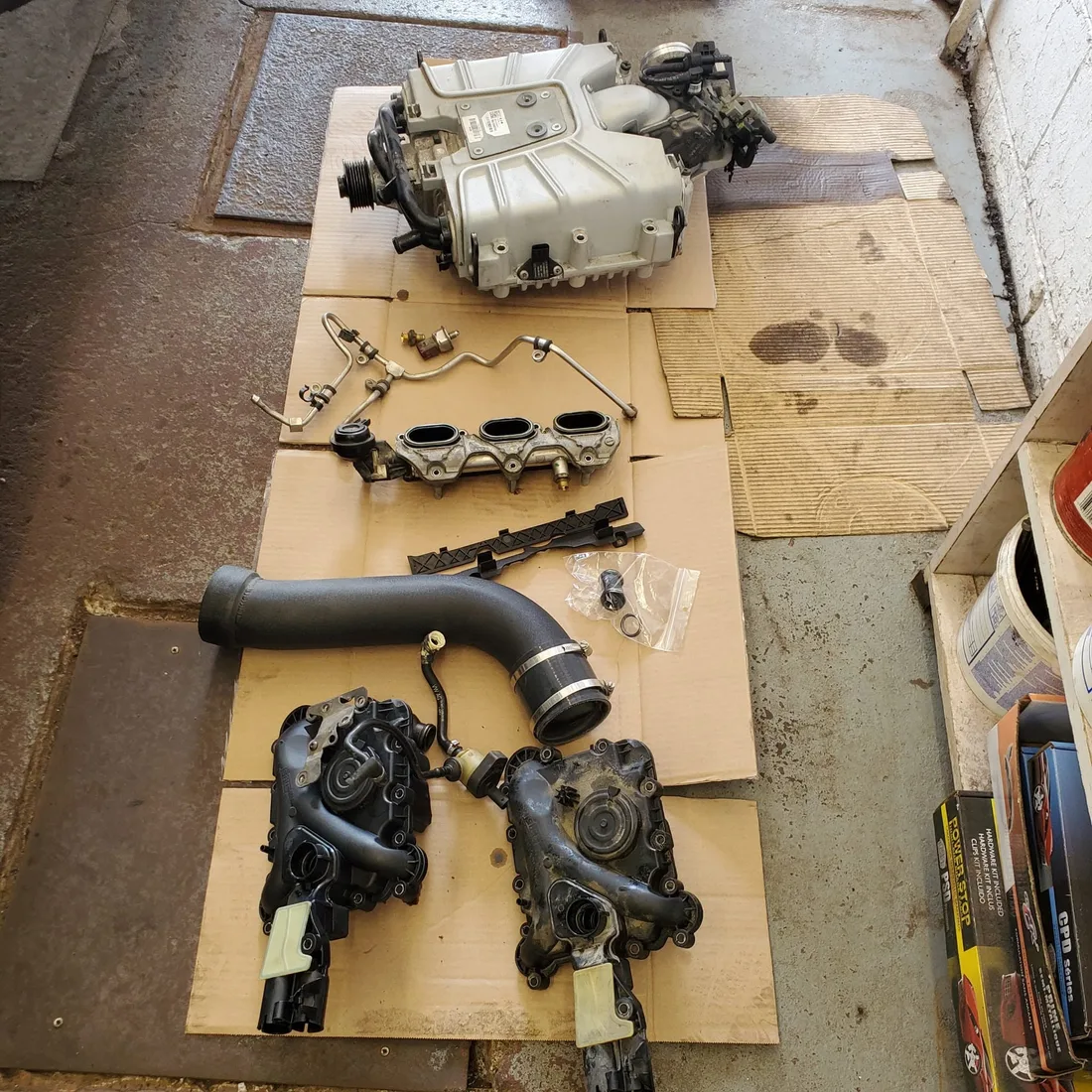 Engine parts laid out during an Audi S4 job at JK Motors